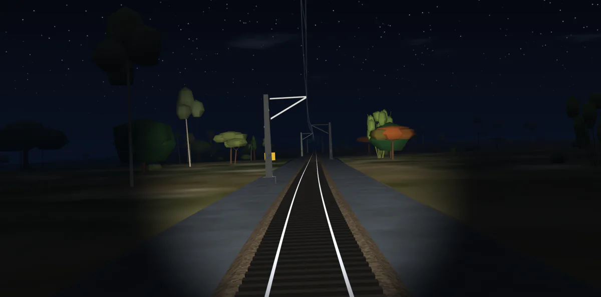 Actual cab view at night: stars overhead, trees in silhouette and the headlight lighting the track and cess ahead